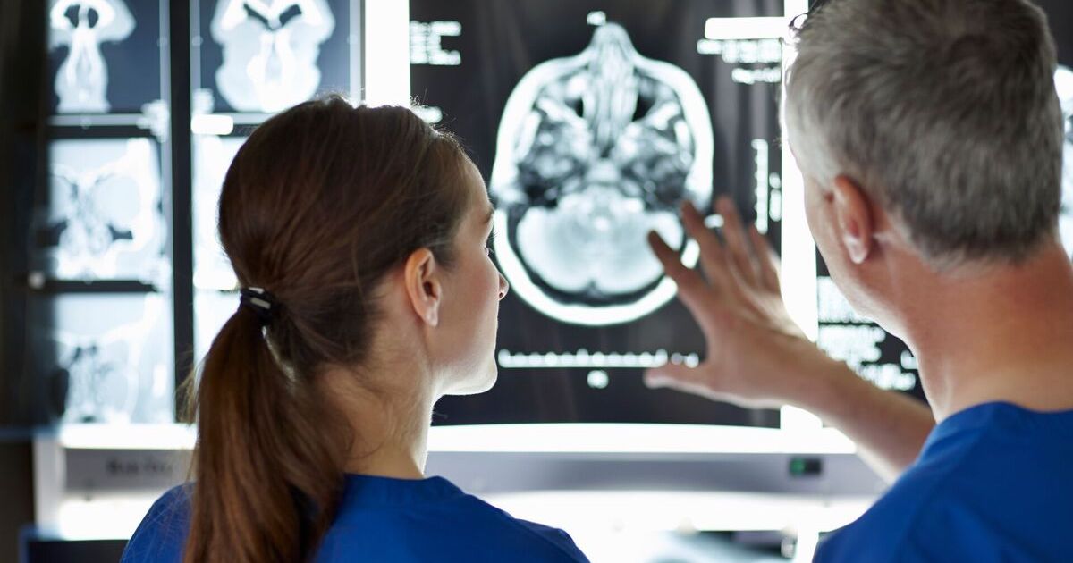 Clinicians inspecting an MRI scan