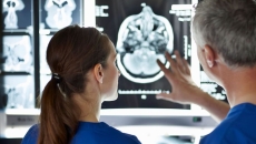 Clinicians inspecting an MRI scan