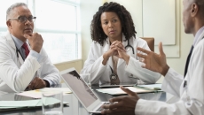Healthcare professionals conferring Healthcare professionals conferring