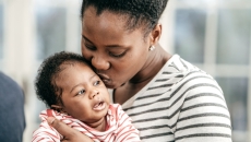 A person holds an infant