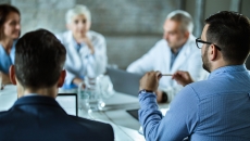 Business persons sitting around a table