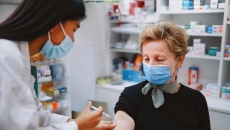 Pharmacist giving a person an injection Pharmacist giving a person an injection