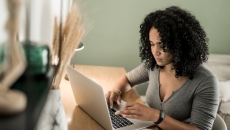 Person sitting at a desk looking at a computer