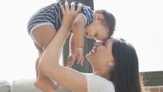 Person holding another person while both are smiling