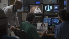 Healthcare professionals reviewing data on computer screens Healthcare professionals reviewing data on computer screens