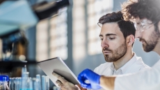 Two healthcare professionals looking at a tablet Two healthcare professionals looking at a tablet