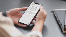 A person using the ThoughtFullChat app on a mobile phone