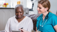 Clinician reviewing healthcare information with a patient with a tablet
