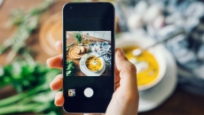 Person taking a photo of their meal with a smartphone