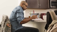 Person sitting at a desk looking at a laptop