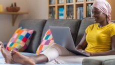 Person using laptop on a couch