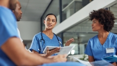 A group of medical practitioners having a discussion in a hospital.