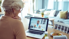 An older woman talking a doctor via telehealth An older woman talking a doctor via telehealth