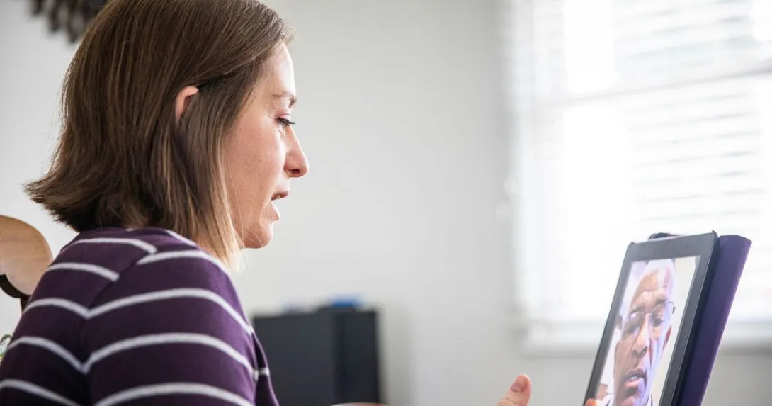 A woman talking to a provider via telehealth A woman talking to a provider via telehealth